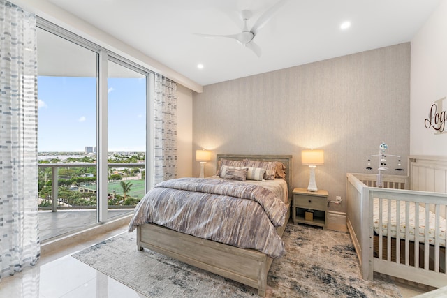 bedroom featuring access to outside, multiple windows, and ceiling fan