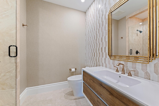 bathroom featuring a shower with door, vanity, and toilet