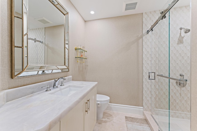 bathroom featuring tile patterned flooring, vanity, an enclosed shower, and toilet