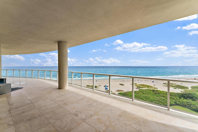 balcony with a water view and a beach view