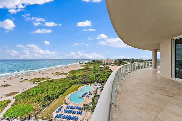 balcony with a beach view and a water view