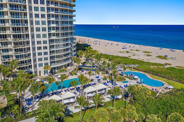 drone / aerial view with a water view and a beach view