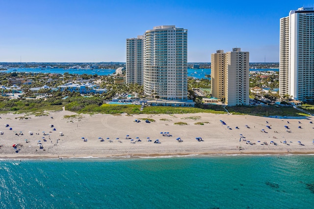 drone / aerial view featuring a water view and a beach view