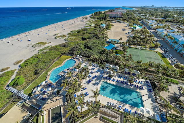 birds eye view of property featuring a water view and a beach view