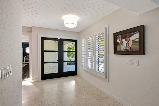 foyer entrance featuring french doors and wood ceiling