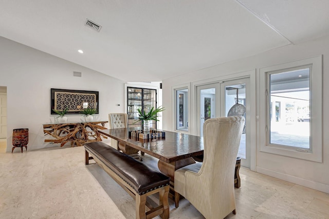 dining room with french doors and lofted ceiling