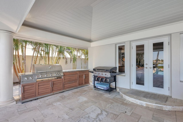 view of patio / terrace with french doors, area for grilling, and a grill