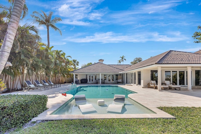 view of pool featuring french doors, a patio, and an outdoor hangout area