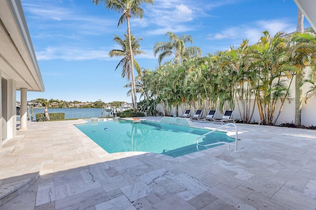 view of pool with a water view and a patio area