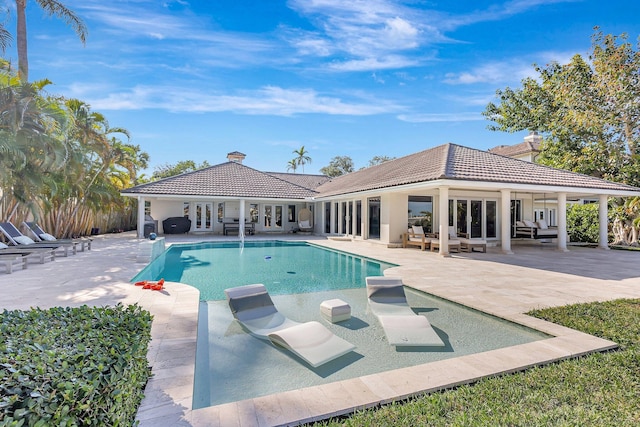 view of pool with a patio area, outdoor lounge area, and french doors