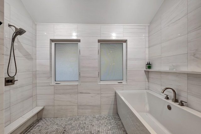 bathroom featuring shower with separate bathtub and vaulted ceiling