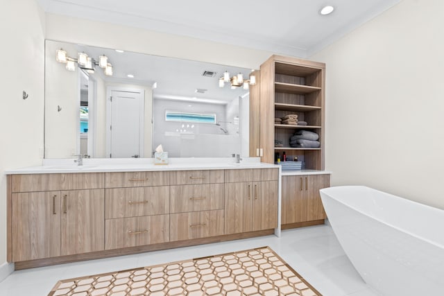 bathroom with tile patterned flooring, a washtub, and vanity