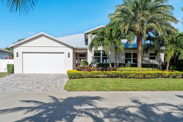 view of front of home with a garage and a front yard