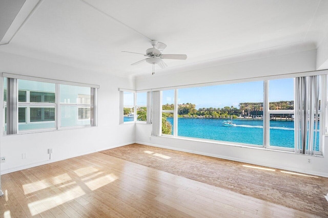 unfurnished sunroom featuring ceiling fan