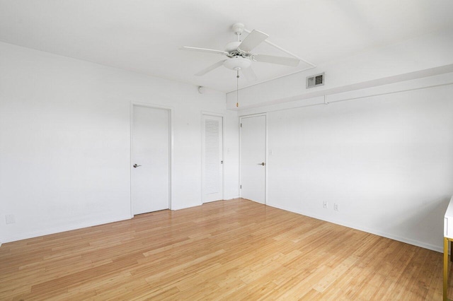 spare room featuring light wood-type flooring and ceiling fan