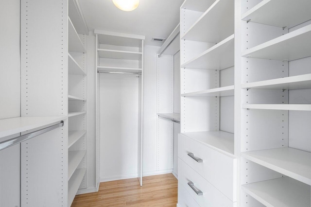 walk in closet featuring light hardwood / wood-style flooring