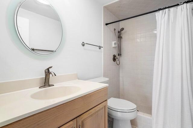 bathroom with toilet, vanity, and a shower with shower curtain