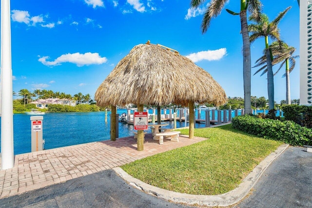 dock area with a water view and a lawn