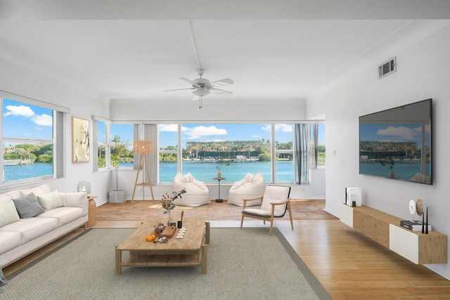 interior space featuring wood-type flooring, a wealth of natural light, and ceiling fan