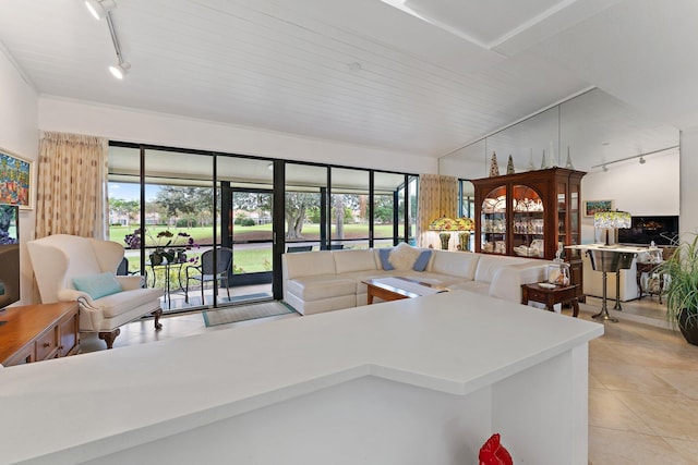 kitchen featuring kitchen peninsula, light tile patterned floors, and track lighting