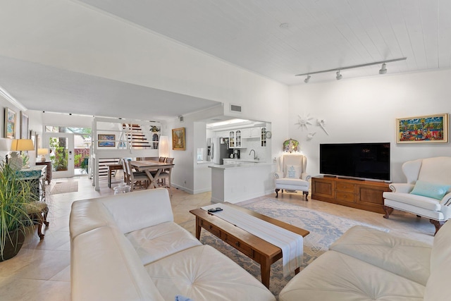 tiled living room with rail lighting, wooden ceiling, and sink