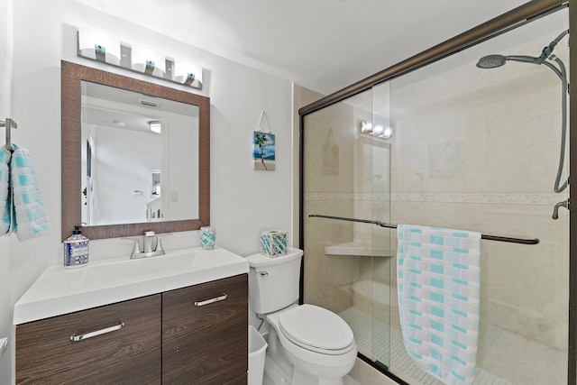 bathroom with toilet, vanity, an inviting chandelier, and walk in shower