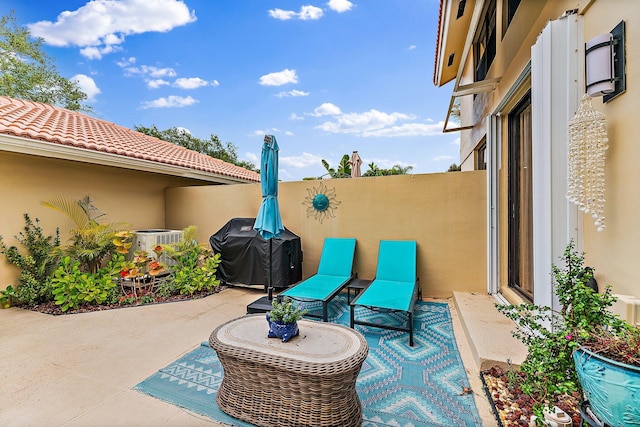 view of patio / terrace with central air condition unit and grilling area