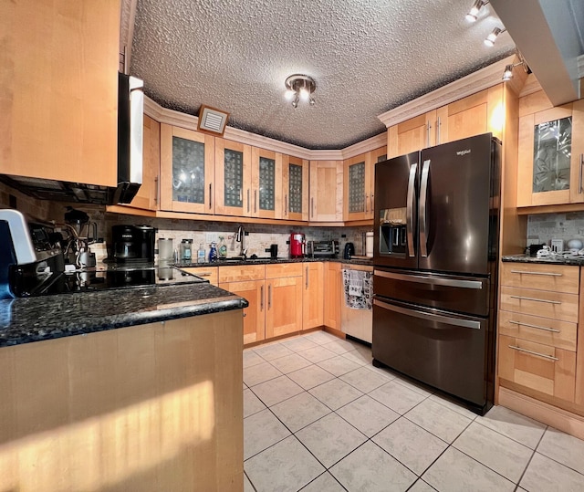 kitchen with sink, refrigerator with ice dispenser, black electric cooktop, light brown cabinetry, and light tile patterned flooring