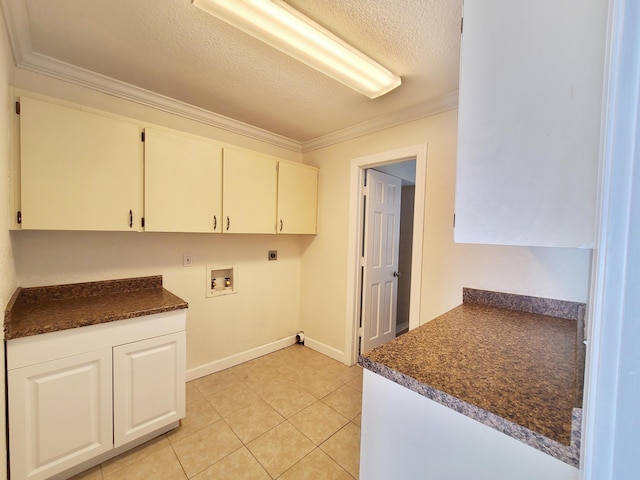 laundry room with hookup for an electric dryer, washer hookup, cabinets, a textured ceiling, and crown molding