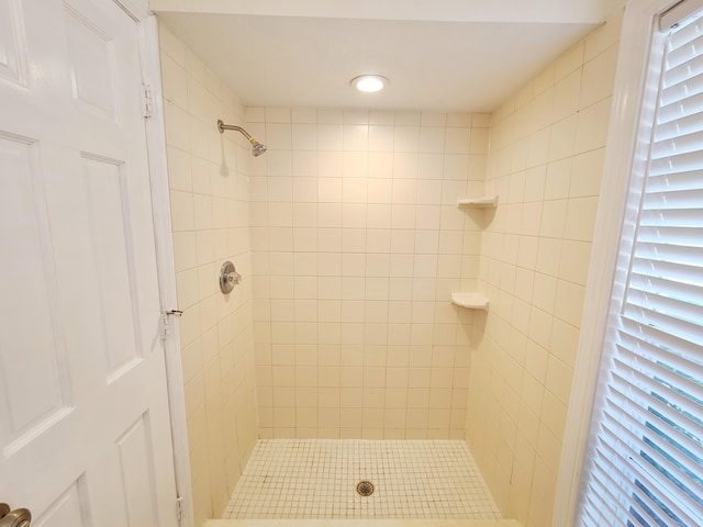 bathroom with tiled shower