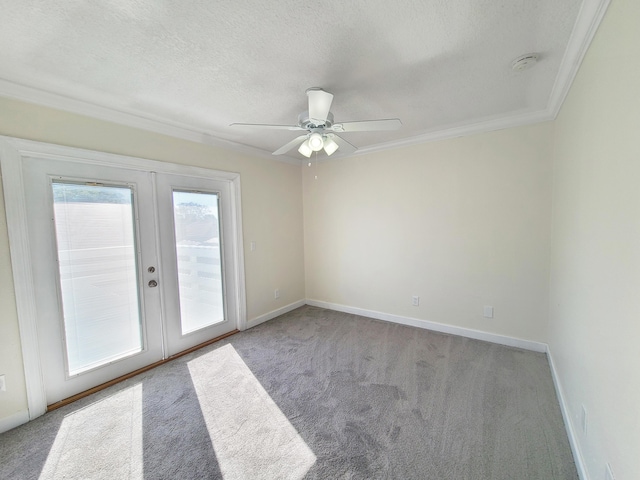 carpeted empty room featuring ceiling fan, french doors, crown molding, and a textured ceiling