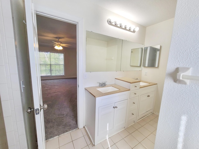 bathroom with tile patterned flooring, ceiling fan, and vanity