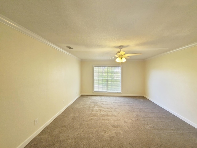 spare room with carpet, a textured ceiling, ceiling fan, and crown molding