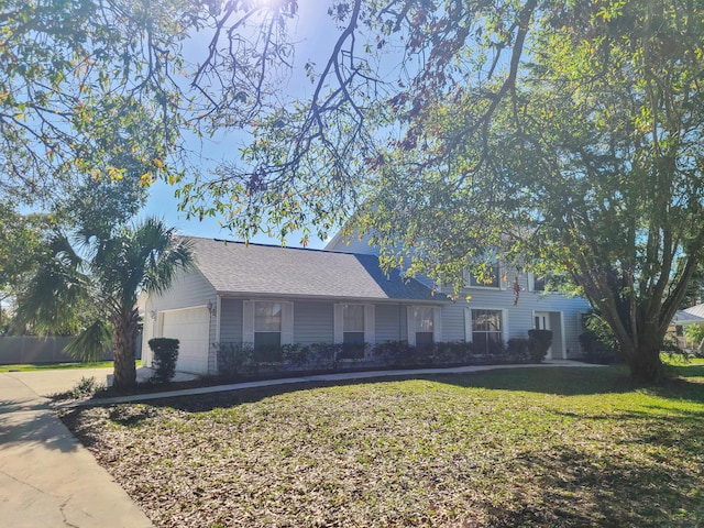 view of front of property featuring a garage and a front lawn