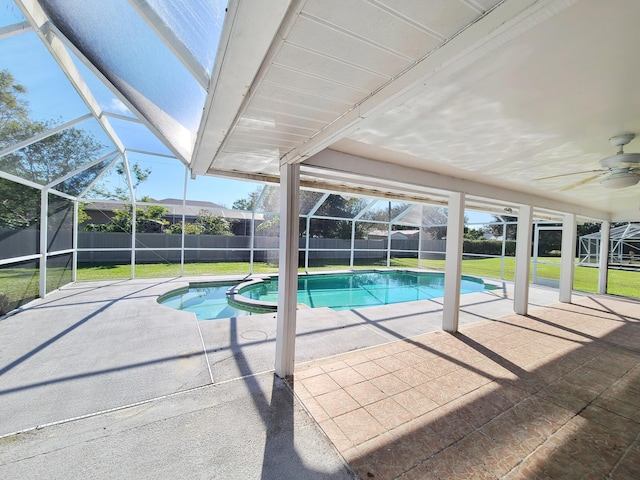 view of pool with a lawn, a patio, and a lanai