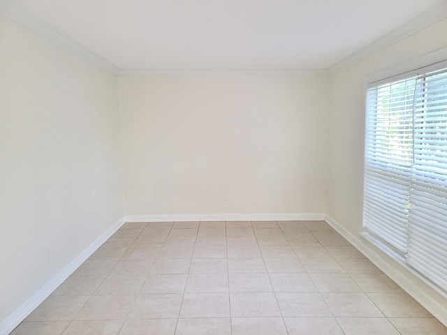 tiled empty room featuring crown molding