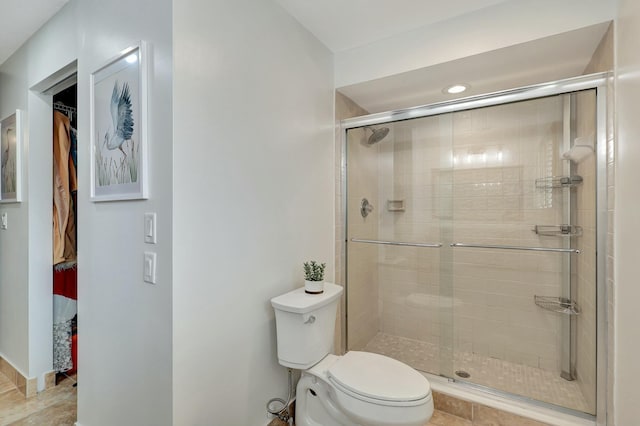 bathroom featuring toilet and walk in shower