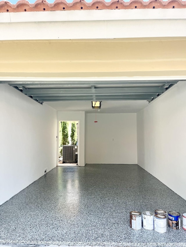 garage featuring cooling unit and a garage door opener