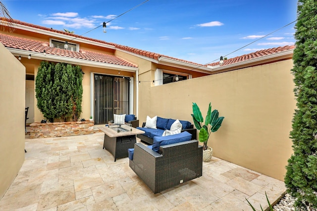 view of patio with an outdoor living space with a fire pit