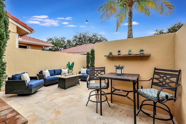 view of patio / terrace featuring an outdoor living space with a fire pit