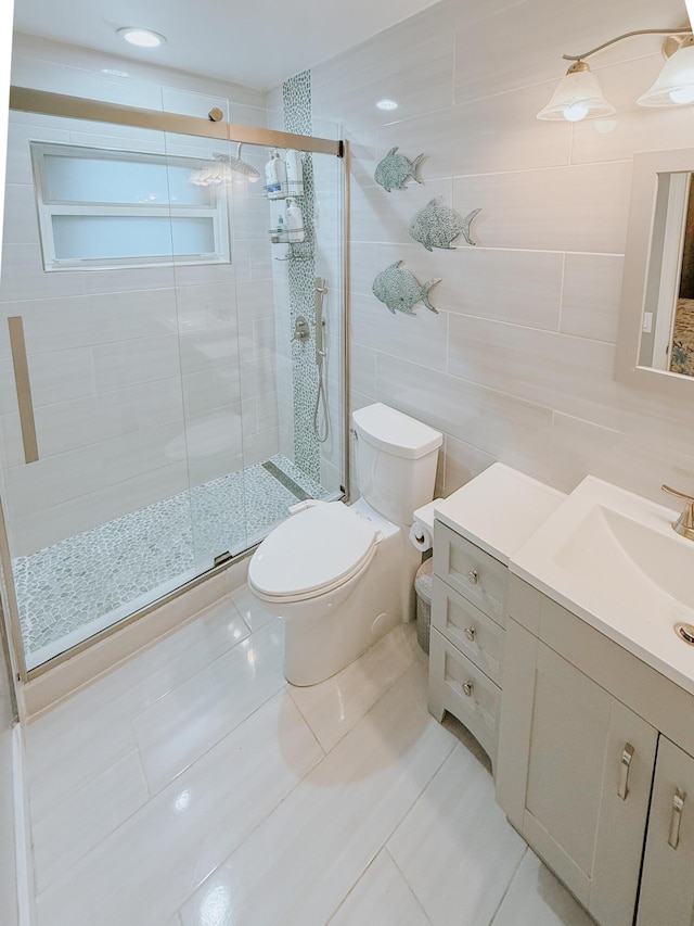 402 Shadow Wood Ln, Coral Springs, FL 33071 - bathroom featuring vanity, a shower with door, tile patterned floors, toilet, and tile walls