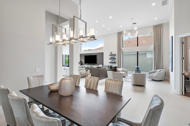 dining room with a high ceiling, an inviting chandelier, and ornamental molding