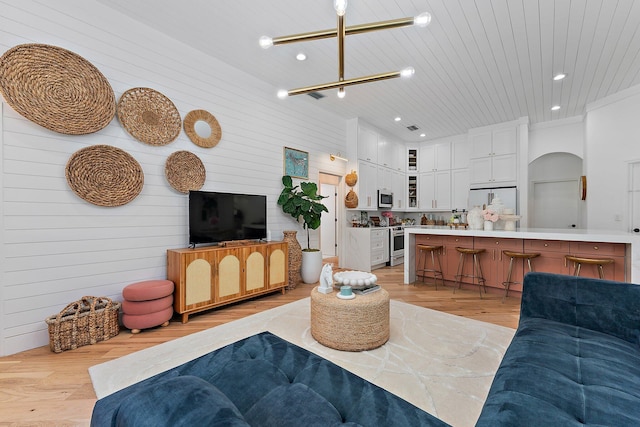 living room featuring wooden ceiling, light hardwood / wood-style floors, and wooden walls