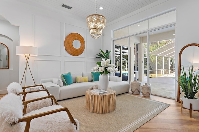 interior space with wooden ceiling, a chandelier, and light wood-type flooring