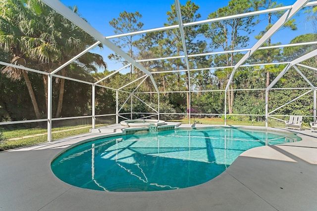 view of swimming pool with a lanai, a patio area, and an in ground hot tub