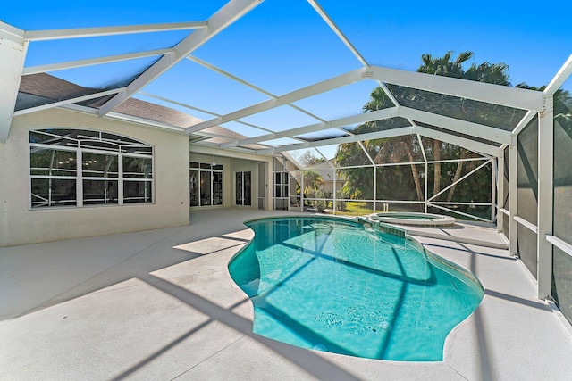 view of pool featuring a patio area, a lanai, and an in ground hot tub