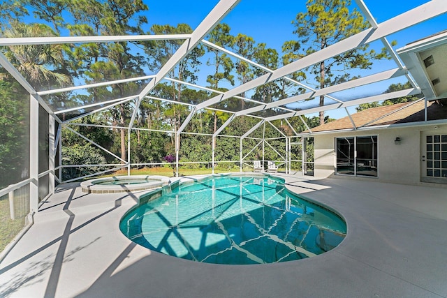 view of pool with an in ground hot tub, a patio, and glass enclosure