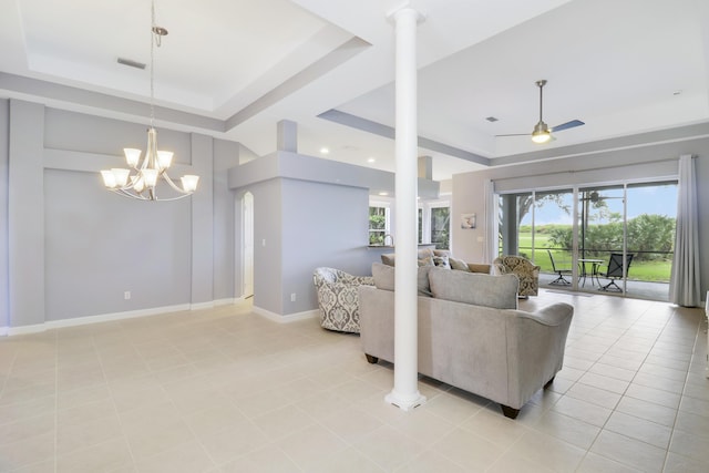 tiled living room featuring ceiling fan with notable chandelier and a raised ceiling