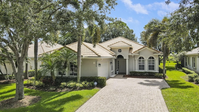 mediterranean / spanish-style home with a front lawn