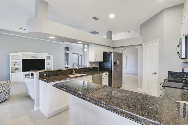 kitchen with white cabinets, light tile patterned floors, stainless steel appliances, and sink